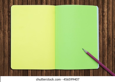 Top view of Creative writing concept with notepad,pencil on wood background. Copy space for text. Blank area for text or message