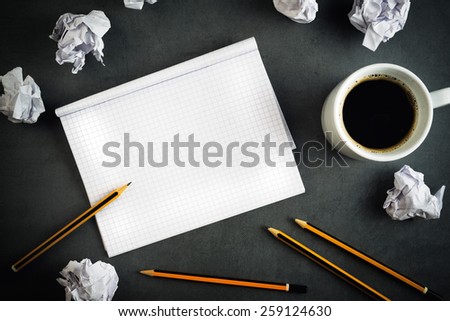 Top View of Creative Writing Concept With Pencils, Coffee Cup, Notepad and Crumpled Paper on Table.
