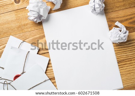 Top view of creative writing concept with papers on wooden table