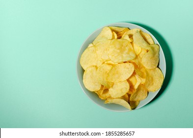 Top View Of Crispy Tomato Chips In The Bowl, Blue Background.Empty Space