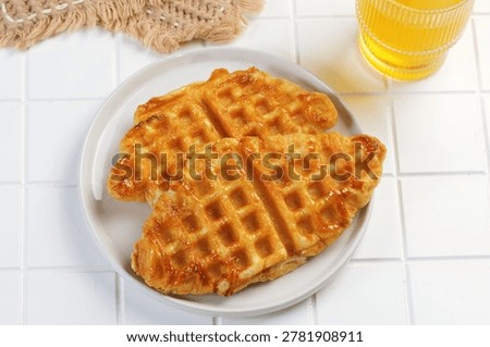Top View of croffle pastry served on plate with honey drink. Sweet bakery dessert concept perfect for breakfast menu and cafe food photography.