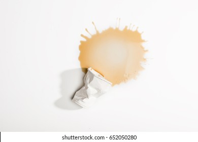 Top View Of Crumpled Used Paper Cup With Spilled Coffee Isolated On White