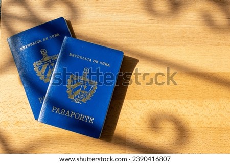 Top view of Cuban passport on wooden table. Identity documents for traveling abroad