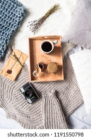 Top View Cup Of Coffee And Can Of Honey In Tray. Knitted Sweater, Envelope And Bunch Of Flowers Locating On Floor. Lunch Concept