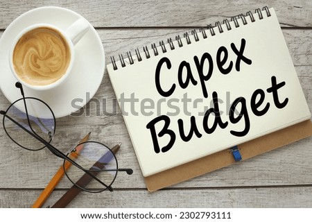 top view of a cup of coffee and a notepad with text CAPEX BUDGET