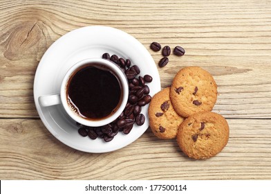 Top View Of Cup Of Coffee And Plate Of Chocolate Cookies