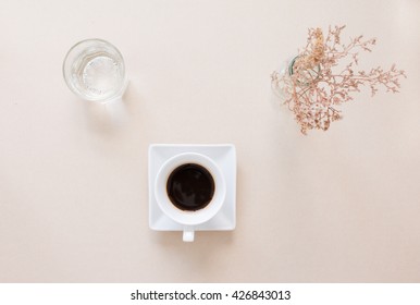 Top View Of A Cup Of Coffee, Water And Dried Flowers.