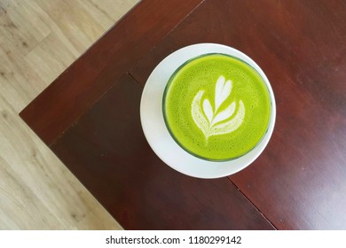 Top View A Cup Of Green Tea Matcha Latte On The Corner Of Wooden Table.