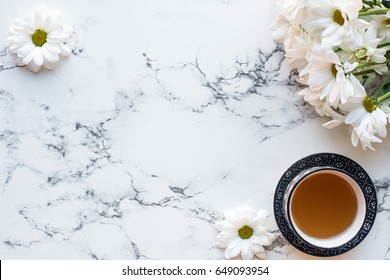 Top View Of Cup Of Tea And Flowers On White Marble Background, Flat Lay