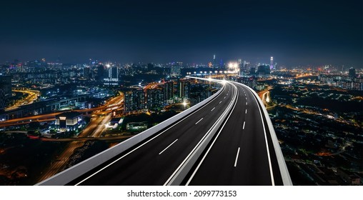 Top view and curvy of Highway overpass with beautiful city background. night scene. - Shutterstock ID 2099773153