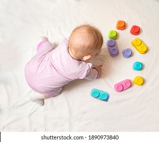 Top view cute small baby playing with colorful blocks , focus on blocks on the floor 