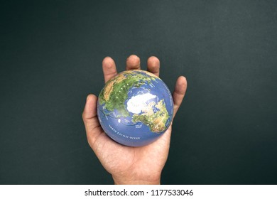 top view of dand holding the globe  - Shutterstock ID 1177533046