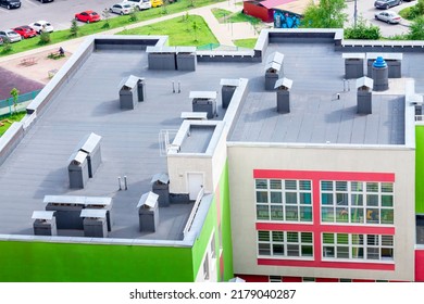 Top View Dark Flat Roof With Air Conditioners And Hydro Insulation Membranes Modern School Building Residential Area.