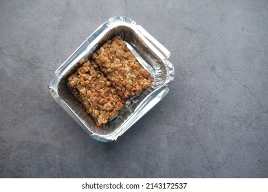 Top View Of Date Fruit Chocolate Bar In A Take Away Container 