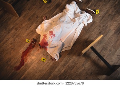 Top View Dead Body Covered With White Sheet At Crime Scene