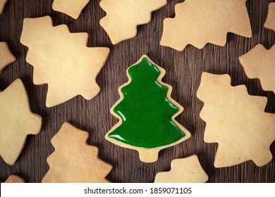 Top View Of Decorated Green Plain Flavor Gingerbread Christmas Tree Cookie On Wooden Table Background With Copy Space, Concept Of Holiday Celebration.