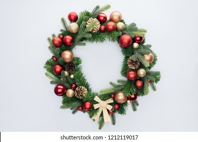 top view of decorative festive wreath with red and golden christmas toys isolated on white - Shutterstock ID 1212119017