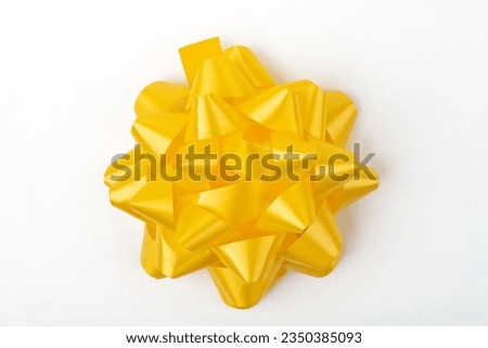 Top View from decorative yellow gift Bow isolated on white background