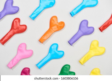 Top View Of Deflated Heart Shaped Balloons On Grey Background