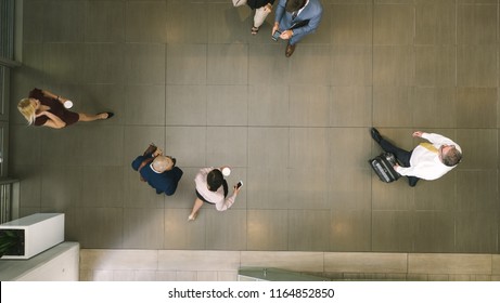 Top View Of Defocused Business People In A Lobby. Business People Walking Through A Office Hallway.