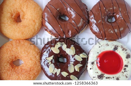 Top view of delectable six doughnuts in various flavors