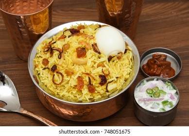 Top View Of Delicious Arabian Mutton Dum Biriyani,  Made With Basmati Rice, Spices. Yogurt, Pickle Side Dish  For Ramadan, Eid Festival Saudi Arabia, Dubai.