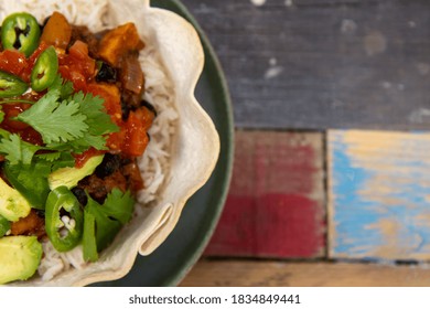 Top View Of A Delicious Black Bean Burrito Bowl On A Wooden Kitchen Work Top