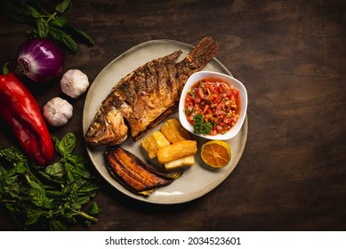 Top View Of A Delicious Fried Tilapia With Yucca And Ripe Plantains From Costa Rica.