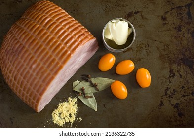 Top View Of Delicious Ham With Yellow Tomatoes, Clove, Dried Mustard And Bay Leaves Horizontal