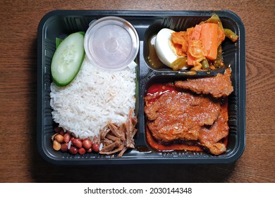 Top View Delicious Nasi Lemak Meal On Take Away Plastic Box. 