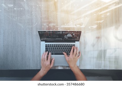 Top View Of Designer Hand Working With Laptop Computer On Wooden Desk As Responsive Web Design Concept