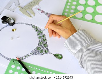 The top view, the designers are coloring the sketch of the unique necklace jewelry with a brush.