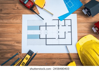 Top view desk of Engineer tools meticulously designs structures at desk, referring to blueprints for precision. Focuses on innovation, problem-solving, and attention to detail in engineering projects