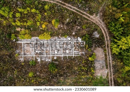 top view of the destroyed building located in the forest. roads and ruins. ruins of a building in a forest area