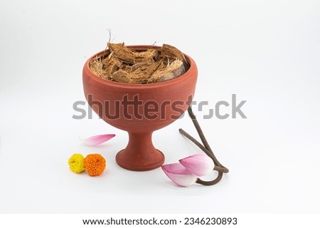 TOP VIEW OF DHUNUCHI WITH LOTUS,MARIGOLD FLOWER ISOLATED WITH SELECTIVE FOCUS.