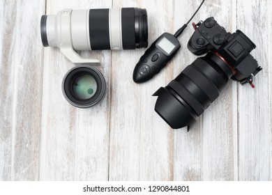 Top view of Digital Camera On White Wooden Background