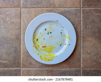 Top View Of Dirty White Plate With Food Leftovers