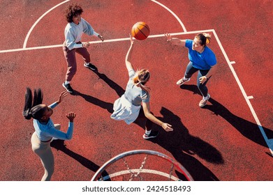 Top view of diverse group of young woman having fun playing basketball outdoors. - Powered by Shutterstock