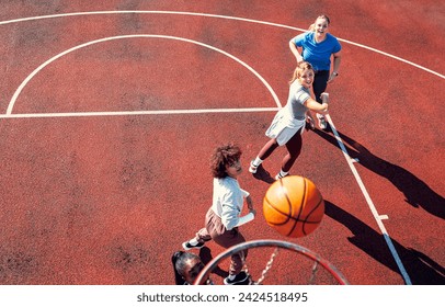 Top view of diverse group of young woman having fun playing basketball outdoors. - Powered by Shutterstock