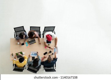 Top View Of Diverse People Of Creative Team Group Using Smartphone, Mobile Phone, Tablet And Computer Laptop. Overhead View Of Asian Young Creative Start Up Meeting. Have Copy Space For Fill Text.