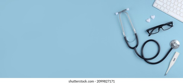 Top View Of Doctor Desk Table With Stethoscope, Blank Paper On Clipboard With Pencil. Top View With Copy Space, Flat Lay.