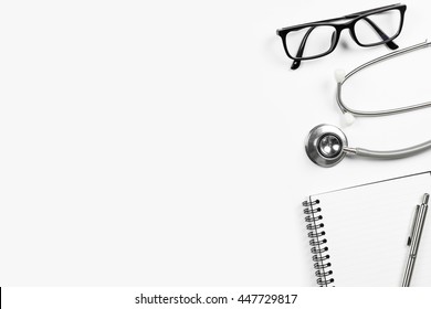 Top view of doctor desk table with stethoscope and notebook with pen. Top view with copy space, flat lay.