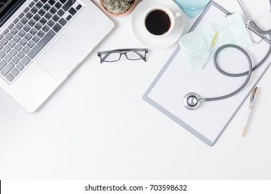 Top View Of Doctor Desk Table With Stethoscope, Coffee  And Notebook With Pen. Top View With Copy Space, Flat Lay.