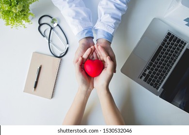 Top View .doctor And Patient Hands Holding Red Heart On White Table, Health Care Love, Give, Hope And Family Concept, World Heart Day,world Health Day