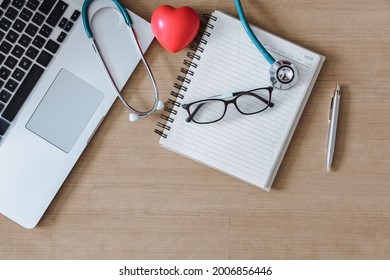 Top View Of Doctor Workspace With Stethoscope And Personal Equipment On Table Desk, Above View Of Doctor Working Space At Clinic Hospital. Health Medical Occupation And Business Healthcare Concept