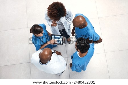 Top view, doctors and nurses with tablet screen, x ray and teamwork for surgery analysis in hospital. People, medical and professional with tech, advice and conversation for cure and share results
