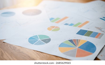Top view documents with analytics data on table. 