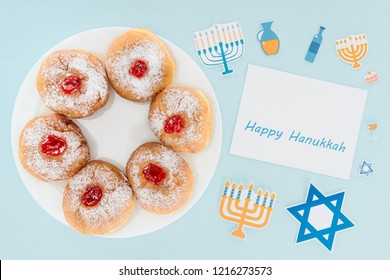 Top View Of Doughnuts On Plate And Happy Hannukah Card Isolated On Blue, Hannukah Concept