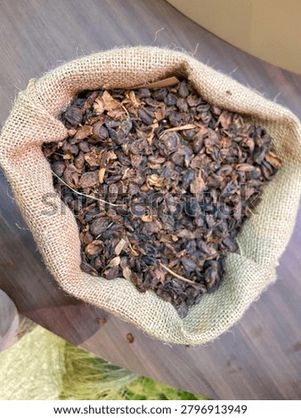 Top view of dried coffee pulp and husks inside a burlap sack, highlighting sustainable eco-friendly coffee byproduct.