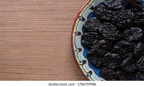 Top View Dried Prunes On A Plate.